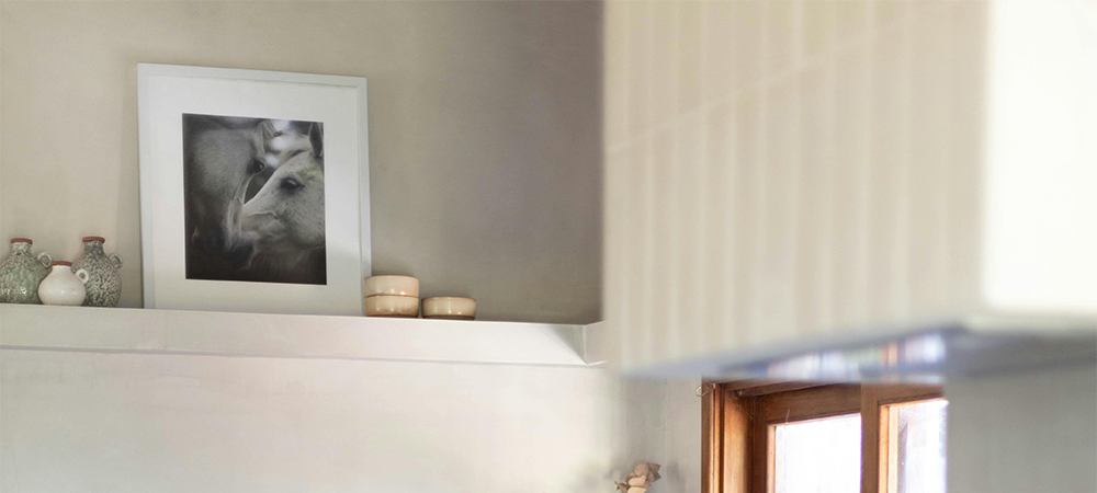 Enhance Small Kitchens with Artwork or Vintage Frames A stylish small kitchen with vintage frames and colorful artwork on the walls