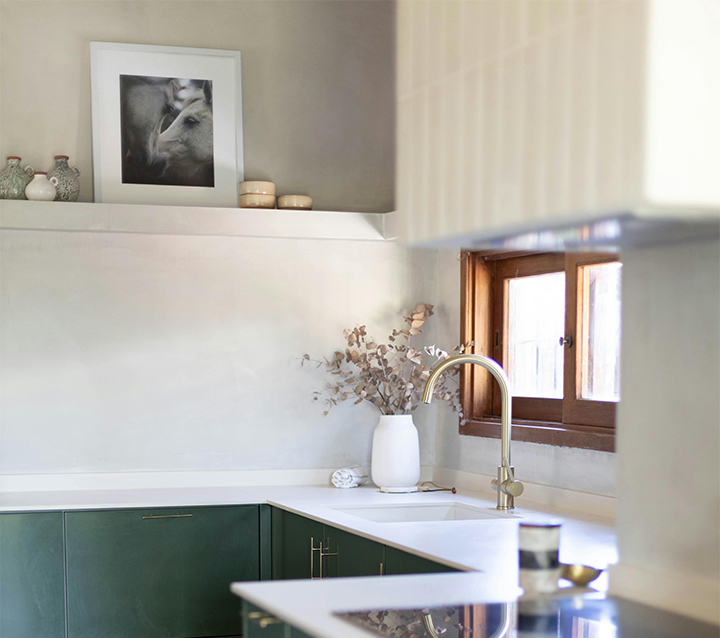 Enhance Small Kitchens with Artwork or Vintage Frames A stylish small kitchen with vintage frames and colorful artwork on the walls