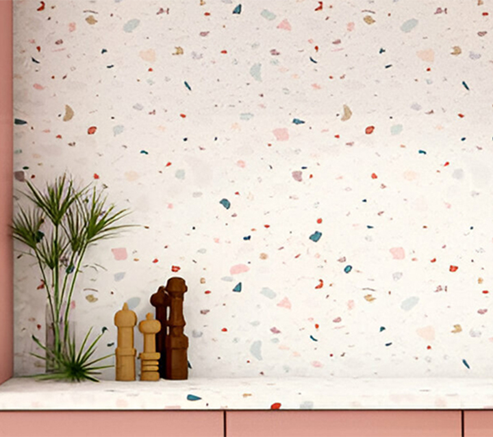 Pink kitchen cabinets with a colorful terrazzo tile backsplash, adding a modern and stylish touch