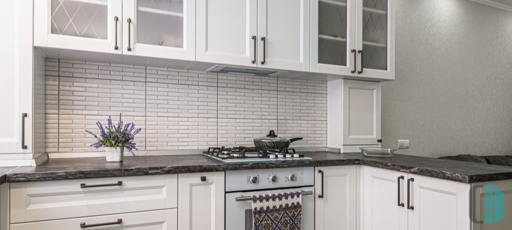 Kitchen cabinets with dark countertops, providing a sleek and modern look with dramatic contrast