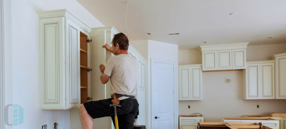 Skilled craftsman applying finishes to cabinet doors