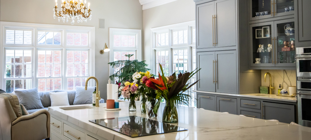 Two-Tone Kitchen with Mixed Cabinet Styles A spacious kitchen with two-tone cabinetry, featuring gray upper cabinets and white lower cabinets with contrasting hardware.