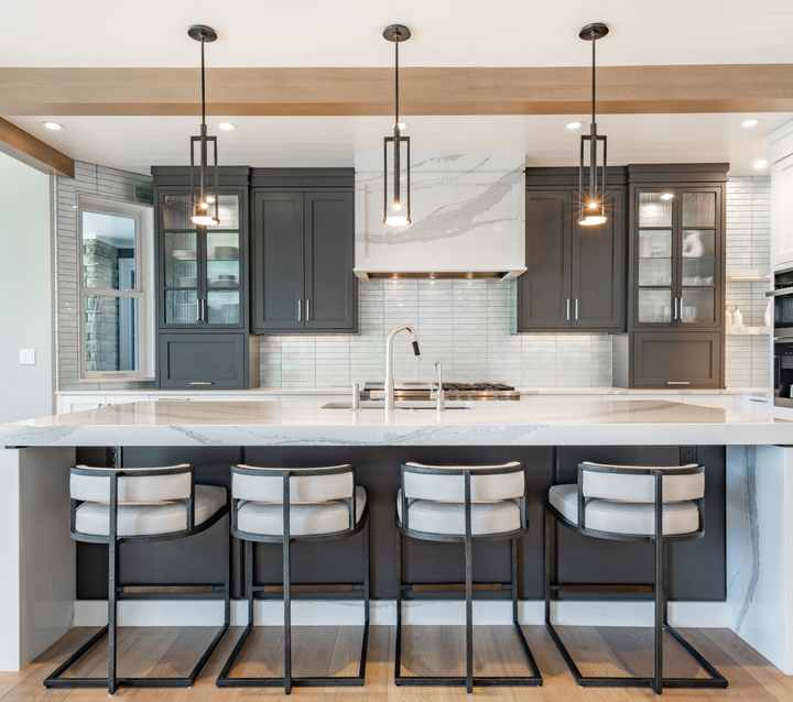 Two-Tone Kitchen with Glass-Front Cabinets A modern kitchen with dark gray cabinets, featuring glass-front cabinets for a stylish and functional look.