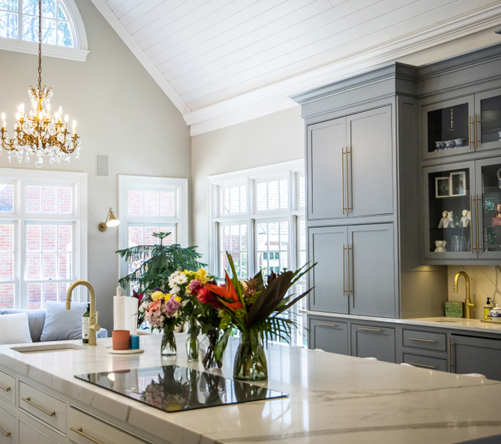 Two-Tone Kitchen with Mixed Cabinet Styles A spacious kitchen with two-tone cabinetry, featuring gray upper cabinets and white lower cabinets with contrasting hardware.