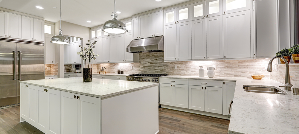 A modern kitchen with all-white shaker cabinets,